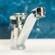 A drop of water drips from a leaky faucet