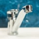 A drop of water drips from a leaky faucet